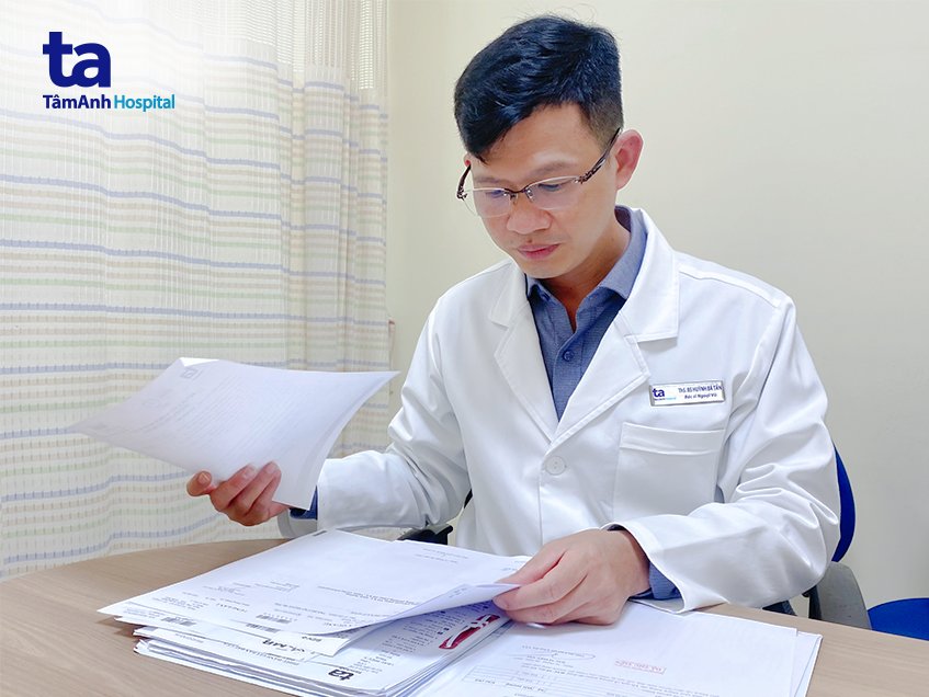 Bác sĩ Tấn xem xét hồ sơ bệnh án