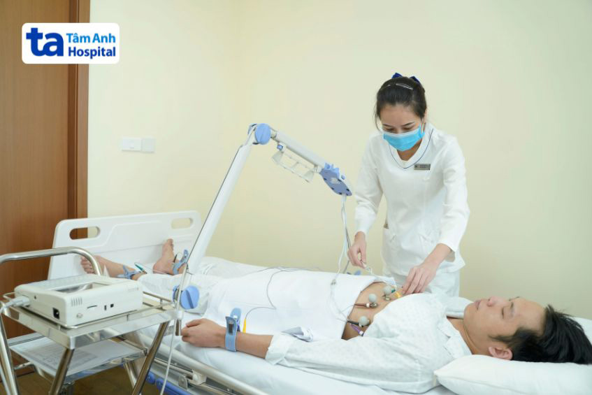 Kỹ thuật viên thực hiện gắn miếng dán điện cực để đo ECG cho bệnh nhân