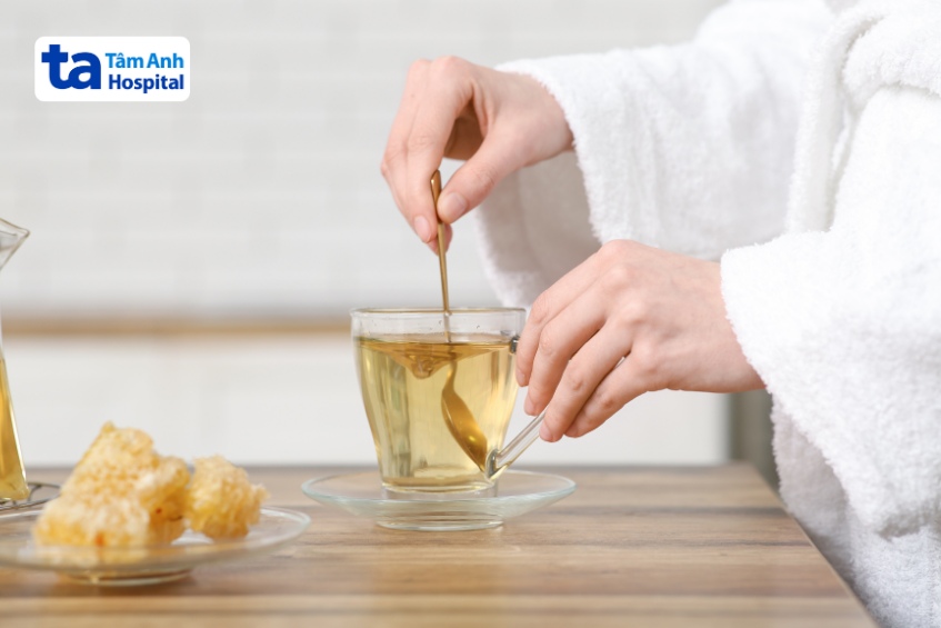 pha loãng mật ong trong nước ấm có thể giúp giảm triệu chứng buồn nôn