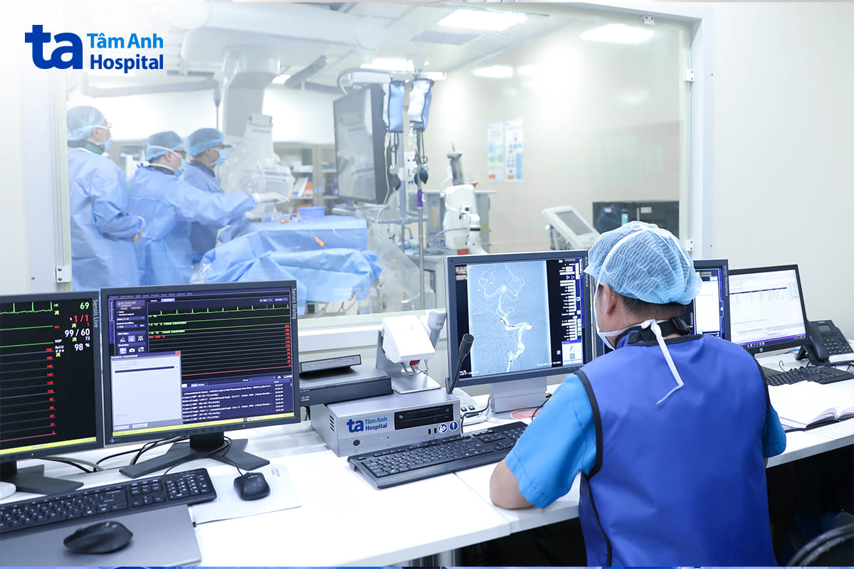 Bác sĩ đang ngồi trong phòng DSA theo dõi phẫu thuật