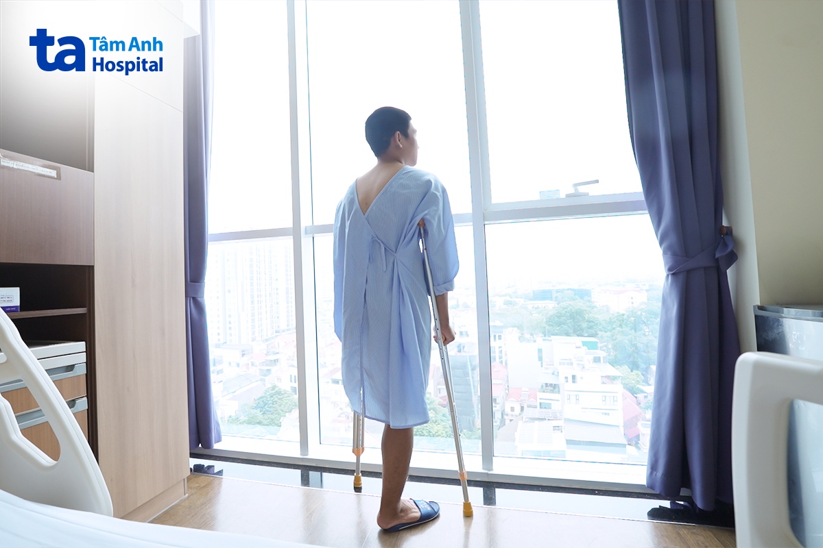 Hưng đi lại bằng nạng. 